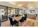 Dining room with sliding glass doors to outdoor sitting area and wooden ceiling at 23240 N Country Club Trl, Scottsdale, AZ 85255