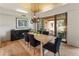 Dining room with wood ceiling, woven pendant lights, and access to an outdoor seating area at 23240 N Country Club Trl, Scottsdale, AZ 85255