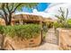 Charming desert home with lush landscaping and a secure gated entrance at 23240 N Country Club Trl, Scottsdale, AZ 85255