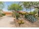 Attractive single-story home with desert landscaping, a spacious driveway, and a two-car garage at 23240 N Country Club Trl, Scottsdale, AZ 85255