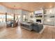 Open-concept living room features a cozy fireplace, wood floors and views of outdoor seating at 23240 N Country Club Trl, Scottsdale, AZ 85255
