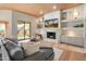 Stylish living room with wood floors, built-ins and a fireplace, open to the backyard at 23240 N Country Club Trl, Scottsdale, AZ 85255