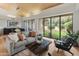 Open living space with wood-slatted ceilings, backyard views, comfortable seating, and natural light at 23240 N Country Club Trl, Scottsdale, AZ 85255