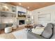 Comfortable living room features custom built-ins, fireplace, wood floors and modern decor at 23240 N Country Club Trl, Scottsdale, AZ 85255
