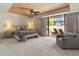 Serene main bedroom with wood-slatted ceiling and patio access with outdoor seating at 23240 N Country Club Trl, Scottsdale, AZ 85255