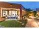 Inviting outdoor living area with a covered patio, lush landscaping, and flagstone pathway at 23240 N Country Club Trl, Scottsdale, AZ 85255