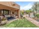 Inviting outdoor living area with a covered patio, swimming pool, and lush desert plants at 23240 N Country Club Trl, Scottsdale, AZ 85255