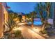 Backyard pool with a stone pathway, desert landscaping, and lounge chairs for relaxing poolside at 23240 N Country Club Trl, Scottsdale, AZ 85255