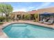Inviting pool area with lounge chairs and lush landscaping, perfect for relaxation and entertainment at 23240 N Country Club Trl, Scottsdale, AZ 85255