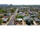 This aerial view showcases a neighborhood with tree-lined streets and a home with a backyard pool at 2545 N 14Th St, Phoenix, AZ 85006