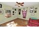 Relaxing bedroom featuring wood floors, natural light, and wall art decor at 2545 N 14Th St, Phoenix, AZ 85006