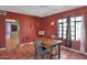 Comfortable dining area with backyard view, an open doorway, and red colored walls at 2545 N 14Th St, Phoenix, AZ 85006