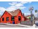 Casa Corazon, a vibrant orange building with a brown roof, has a sign and outdoor seating at 2545 N 14Th St, Phoenix, AZ 85006
