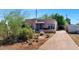 A cozy home with a desert landscape and a charming, covered front porch with blue accents at 2545 N 14Th St, Phoenix, AZ 85006