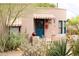 Cozy home exterior with a charming blue door, surrounded by desert flora and mature landscaping at 2545 N 14Th St, Phoenix, AZ 85006