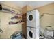 Functional laundry room with shelving and stacked washer and dryer for convenience at 2545 N 14Th St, Phoenix, AZ 85006