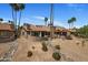 Aerial view of desert home with private patios surrounded by desert landscape and mature palm trees at 25609 N Forest Rd # 13, Rio Verde, AZ 85263