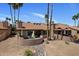 Aerial view of desert home, showcasing patio, and native landscaping, including palm trees at 25609 N Forest Rd # 13, Rio Verde, AZ 85263