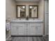 Modern bathroom vanity featuring double sinks, white cabinets, and framed mirrors with views into the Primary bath at 25609 N Forest Rd # 13, Rio Verde, AZ 85263
