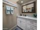 Cozy bathroom vanity featuring white cabinets, marbled countertop, and attractive decor at 25609 N Forest Rd # 13, Rio Verde, AZ 85263