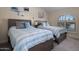 Charming bedroom with two beds, neutral tones, and a large window offering bright, natural light at 25609 N Forest Rd # 13, Rio Verde, AZ 85263