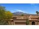 Exterior view of home showing tile roof, 2-car garage and mountain view in the background at 25609 N Forest Rd # 13, Rio Verde, AZ 85263