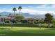People enjoying a golf game on a beautiful green course with mountain views and blue skies at 25609 N Forest Rd # 13, Rio Verde, AZ 85263