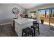 Bright kitchen features a marble island with seating and view to the outdoor patio at 25609 N Forest Rd # 13, Rio Verde, AZ 85263