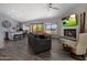 Bright living room featuring a fireplace, large windows and sleek modern furnishings at 25609 N Forest Rd # 13, Rio Verde, AZ 85263