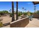Desert home patio with outdoor dining, palm trees, and desert landscape at 25609 N Forest Rd # 13, Rio Verde, AZ 85263