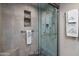 Beautiful tiled shower featuring a glass door, mosaic tile accents, and updated shower head at 25609 N Forest Rd # 13, Rio Verde, AZ 85263