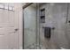 Updated tile shower featuring glass enclosure, corner seat and mosaic niche for toiletries at 25609 N Forest Rd # 13, Rio Verde, AZ 85263