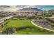 Stunning aerial view showcases the community park, lush green space, and mountain backdrop at 2597 E Hickory St, Gilbert, AZ 85298