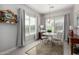 Bright dining area with natural light, modern chandelier, neutral colors, and elegant curtains at 2597 E Hickory St, Gilbert, AZ 85298
