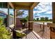 Cozy front porch features stone pillars, neutral paint, and relaxing seating area overlooking the street at 2597 E Hickory St, Gilbert, AZ 85298