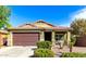 Charming single-story home with a well-maintained front yard and a two-car garage at 2597 E Hickory St, Gilbert, AZ 85298