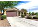 Inviting single-story home with desert landscaping and long driveway leading to a 2-car garage at 2597 E Hickory St, Gilbert, AZ 85298