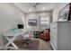 Bright home office features a modern white desk, a comfortable chair, and a nice dresser at 2597 E Hickory St, Gilbert, AZ 85298