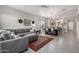 Spacious living room featuring tile flooring, a comfortable sectional sofa, and open floor plan at 2597 E Hickory St, Gilbert, AZ 85298