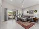 Comfortable living room with tile flooring, neutral color palette, and access to the outdoor patio at 2597 E Hickory St, Gilbert, AZ 85298