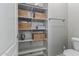 Pantry featuring shelving with wicker baskets and gray flooring at 2597 E Hickory St, Gilbert, AZ 85298