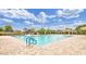 Community pool area surrounded by a spacious deck and lush landscaping at 2597 E Hickory St, Gilbert, AZ 85298