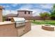 Backyard featuring a built-in grill with side burner and fire pit at 26956 N 83Rd Gln, Peoria, AZ 85383