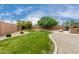 Spacious backyard including grass, desert landscaping, pool and built-in grill at 26956 N 83Rd Gln, Peoria, AZ 85383