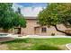Manicured backyard with built-in grill, fire pit, pool, and covered patio at 26956 N 83Rd Gln, Peoria, AZ 85383