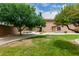 Lush backyard with in-ground pool, built-in grill, and mature trees at 26956 N 83Rd Gln, Peoria, AZ 85383