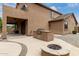 Expansive backyard featuring a built-in grill, fire pit and covered patio area at 26956 N 83Rd Gln, Peoria, AZ 85383
