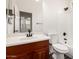 Bright bathroom featuring a wood vanity, white countertops, and a shower over a tub at 26956 N 83Rd Gln, Peoria, AZ 85383