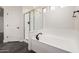 Modern bathroom with a glass-enclosed shower, soaking tub, and black hardware accents at 26956 N 83Rd Gln, Peoria, AZ 85383