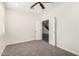 Neutral carpet, a ceiling fan, and white trim highlight this bedroom's features at 26956 N 83Rd Gln, Peoria, AZ 85383